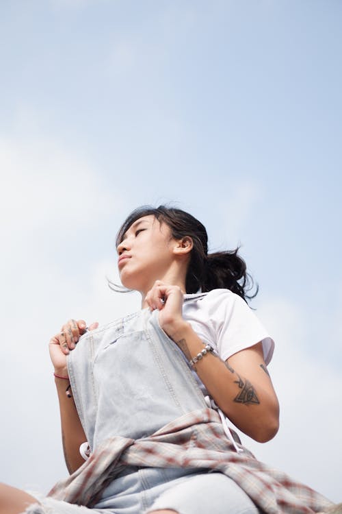 Low-Angle Shot of a Woman in Denim Jumper