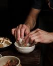 Close up on man breaking egg in pot