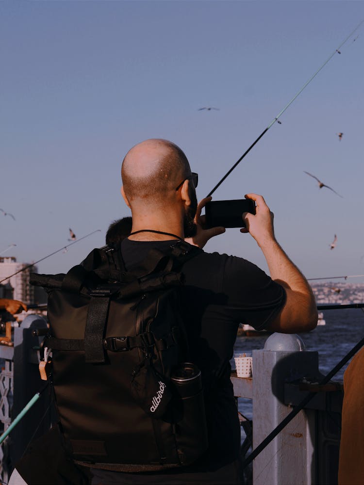 Man Photographing With Smartphone