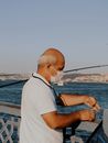 A Man  Wearing Face Mask Holding a Worm