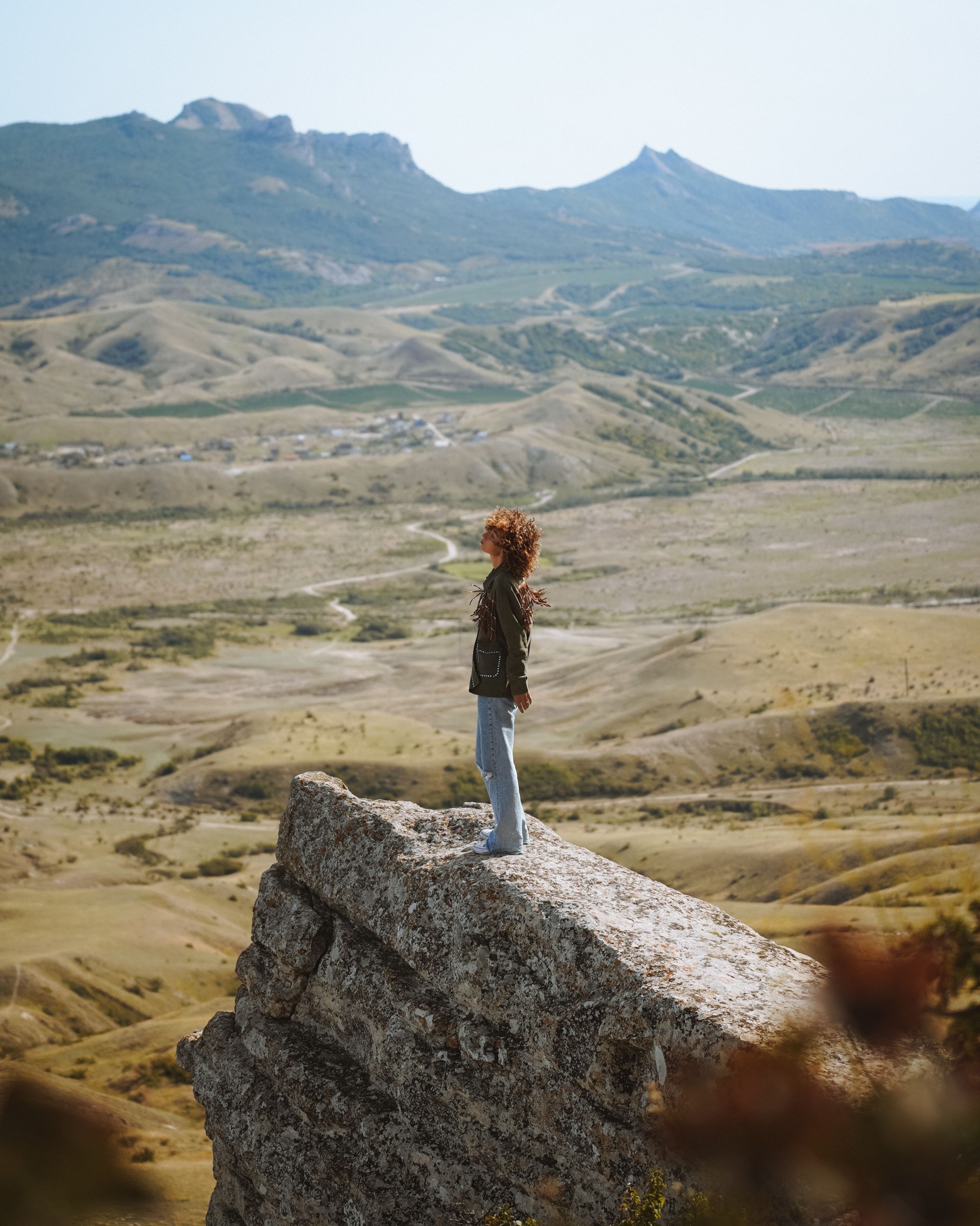 Woman in White Shirt and Black Shorts Sitting on Rock · Free Stock Photo