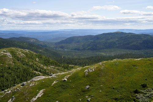 Free Breathtaking panoramic view of lush green mountains under a clear blue sky. Perfect for nature enthusiasts. Stock Photo