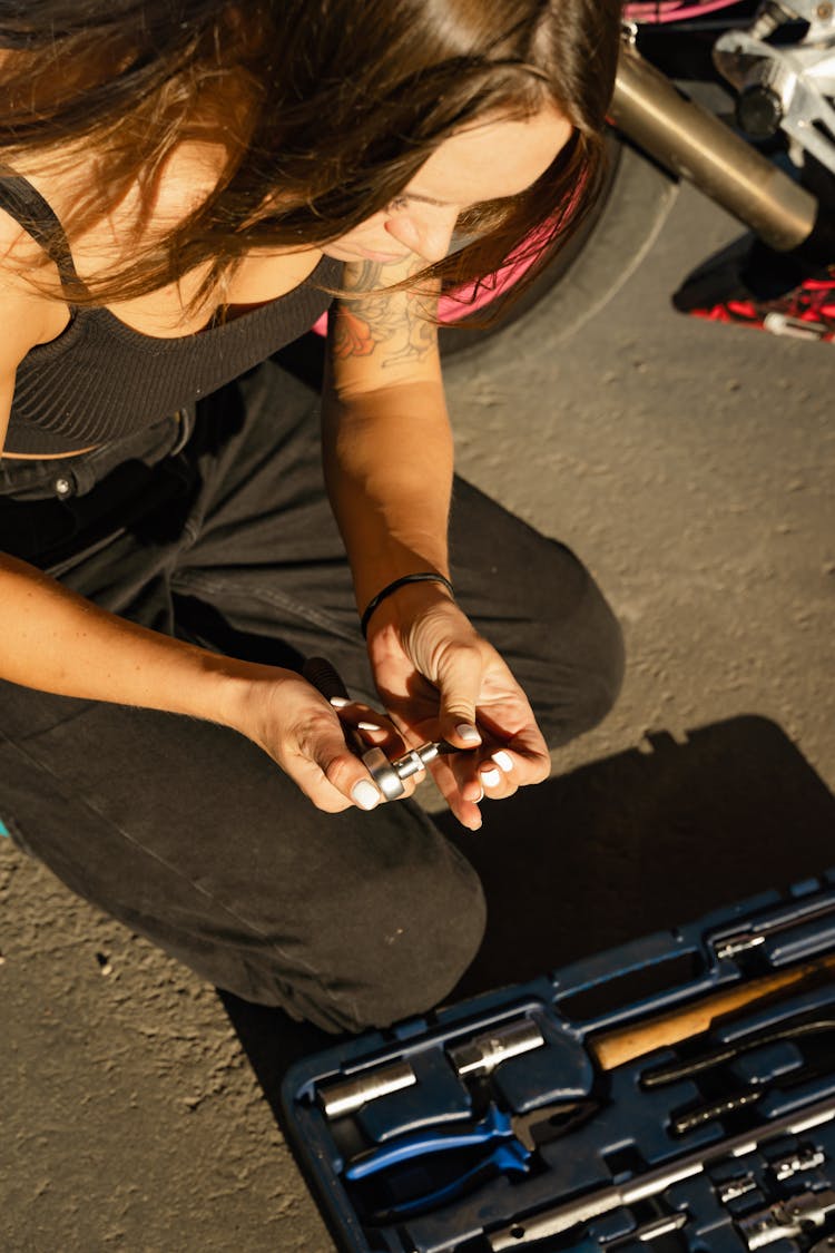 A Woman Holding A Wrench