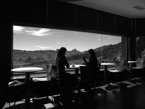 Free Two women enjoy coffee in a cafe with a panoramic mountain view. Stock Photo