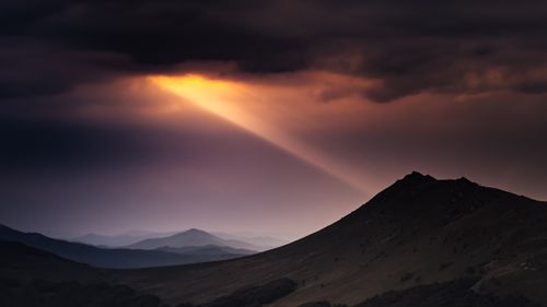 Free A stunning sunset with light beams over Bieszczady Mountains, Poland. Stock Photo
