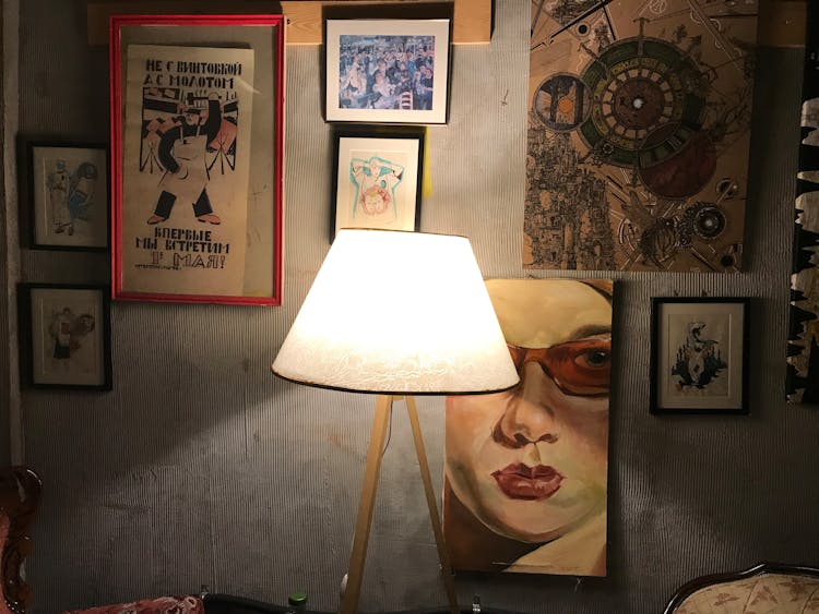 White Lamp Near Frames On Wall 