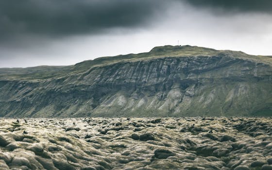 Majestic Icelandic volcanic landscape with moody skies and rugged mountains showcasing nature's beauty.
