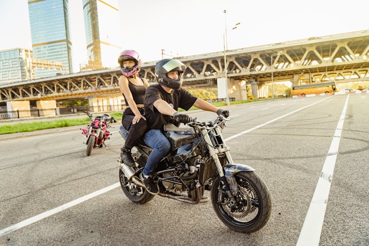 Man And Woman Riding Motorcycle