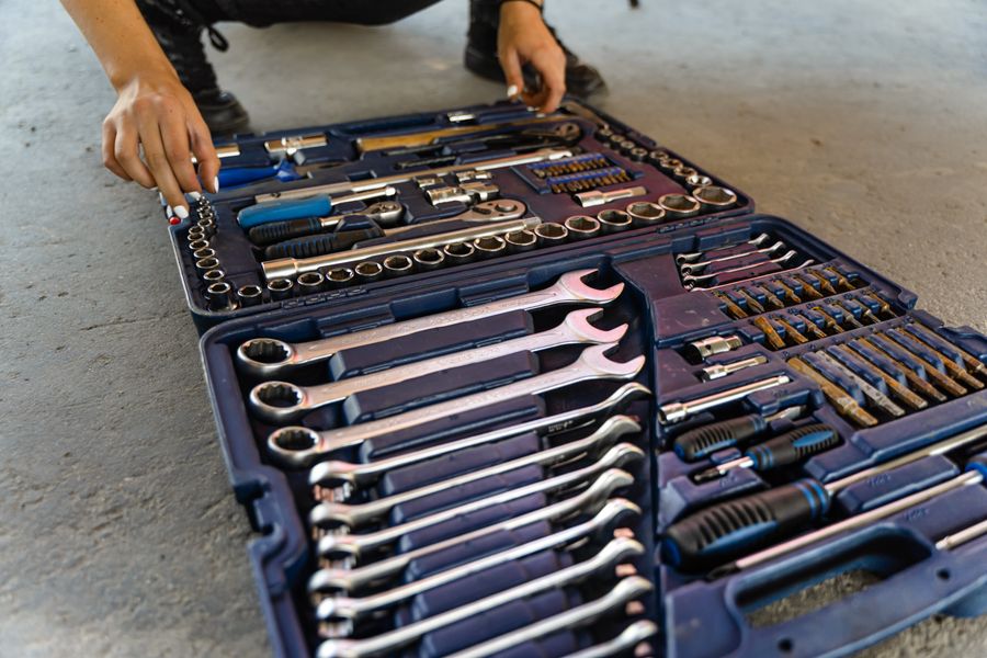 Organised garage tool collection with wrenches and socket sets