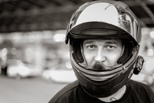 Black and White Photo of Man Wearing Helmet