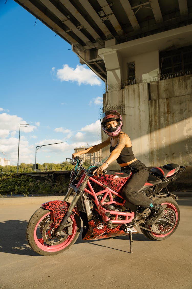 Woman Riding On A Red Motorbike