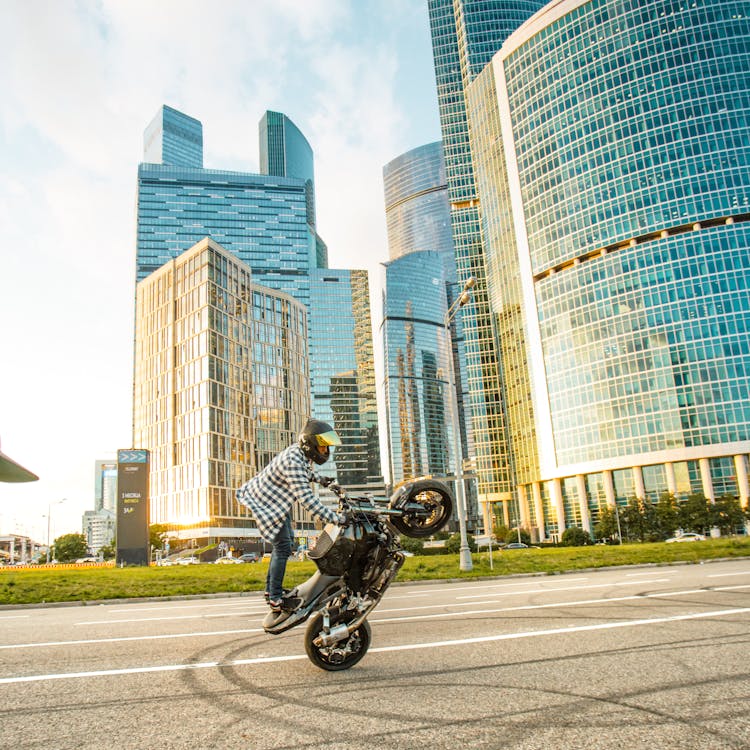 Person Standing On A Motorcycle 