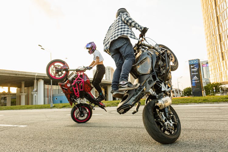 Couple Doing Motorcycle Stunts