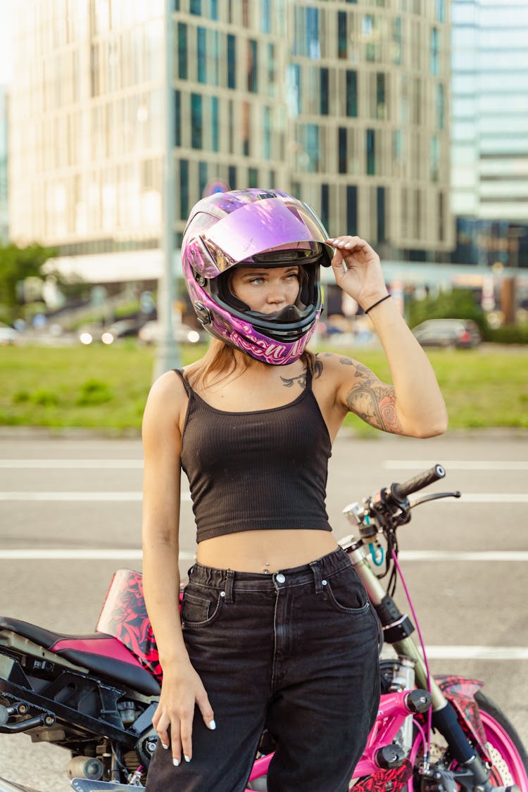 A Woman Wearing Purple Motorcycle Helmet