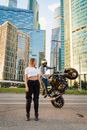 Man in White Shirt and Black Pants Standing Beside Motorcycle