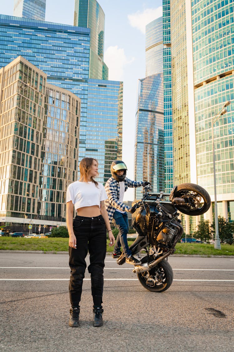 Biker Doing A Stunt Near A Woman