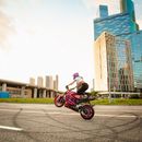A Woman doing Wheelie