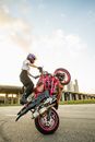 Man in Black Shirt Riding Red Motorcycle
