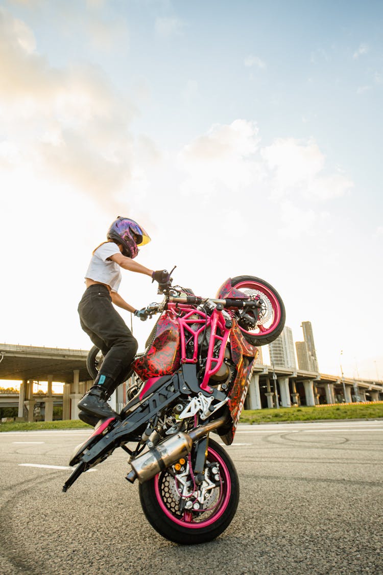 A Woman Doing A Stunt On A Motorcycle