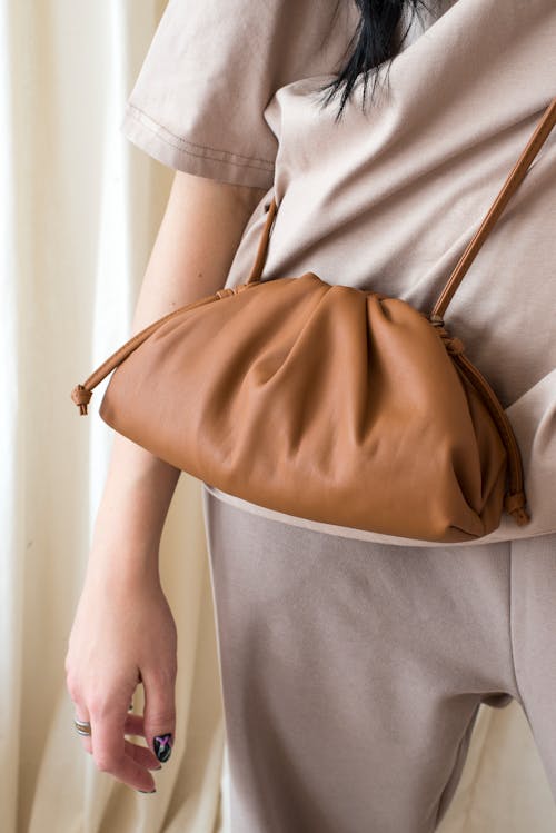 Woman in Gray Shirt Carrying Brown Leather Sling Bag