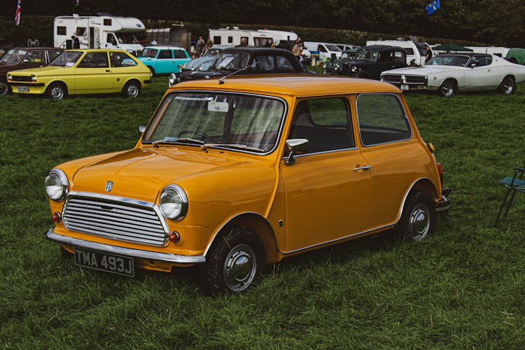 Vintage Car Rally And Campers In Green Field