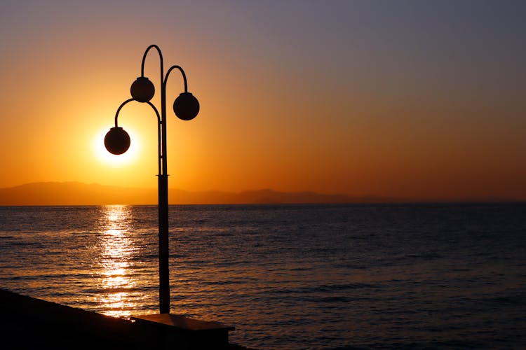 Streetlight Silhouette On Sunset Sky