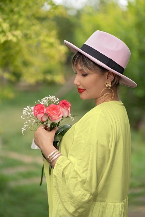 Woman in Yellow Dress with Hat  Holding Flowers