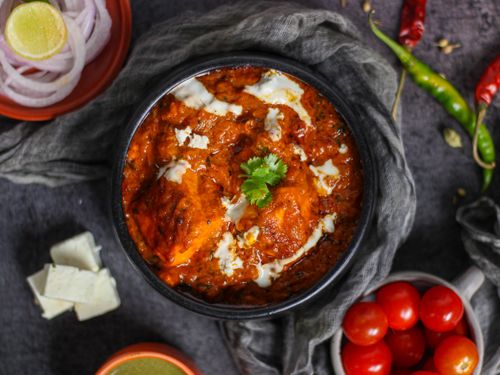 Free Savory paneer makhani dish with rich tomato sauce and fresh garnishes captured in an overhead shot. Stock Photo