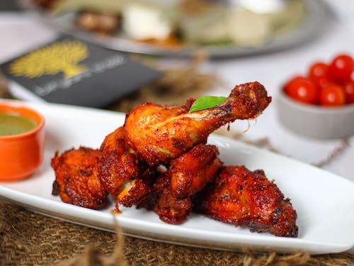 Close-Up Shot of Delicious Fried Chicken on White Ceramic Plate