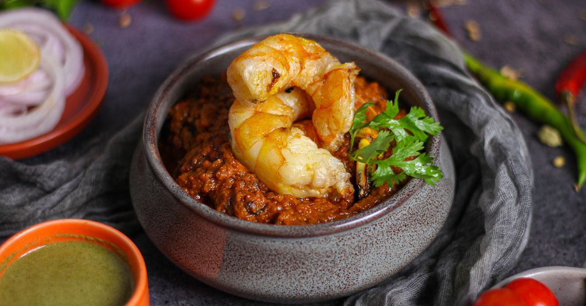 A close-up shot of dark, thick shito in a clay pot with visible fish and shrimp pieces