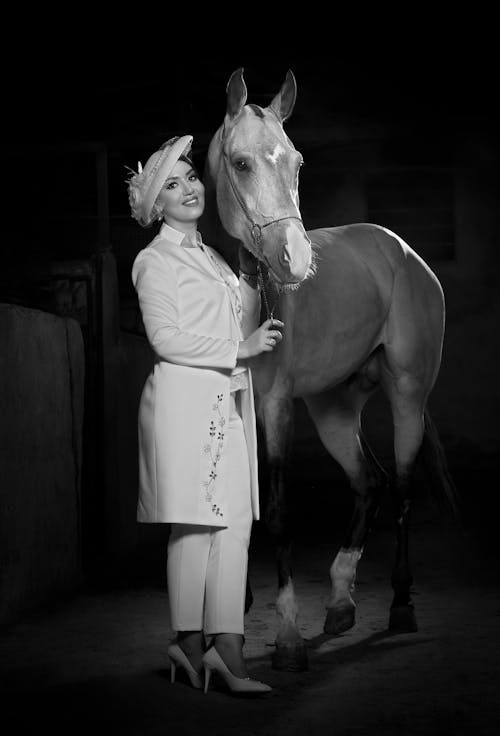 Black and White Photo of an Elegant Woman and a Horse