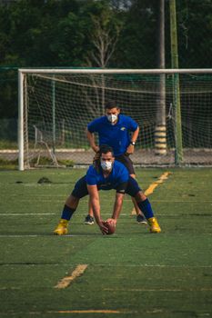 John Tuggle on the field demonstrating professional reliability tips during a practice session.