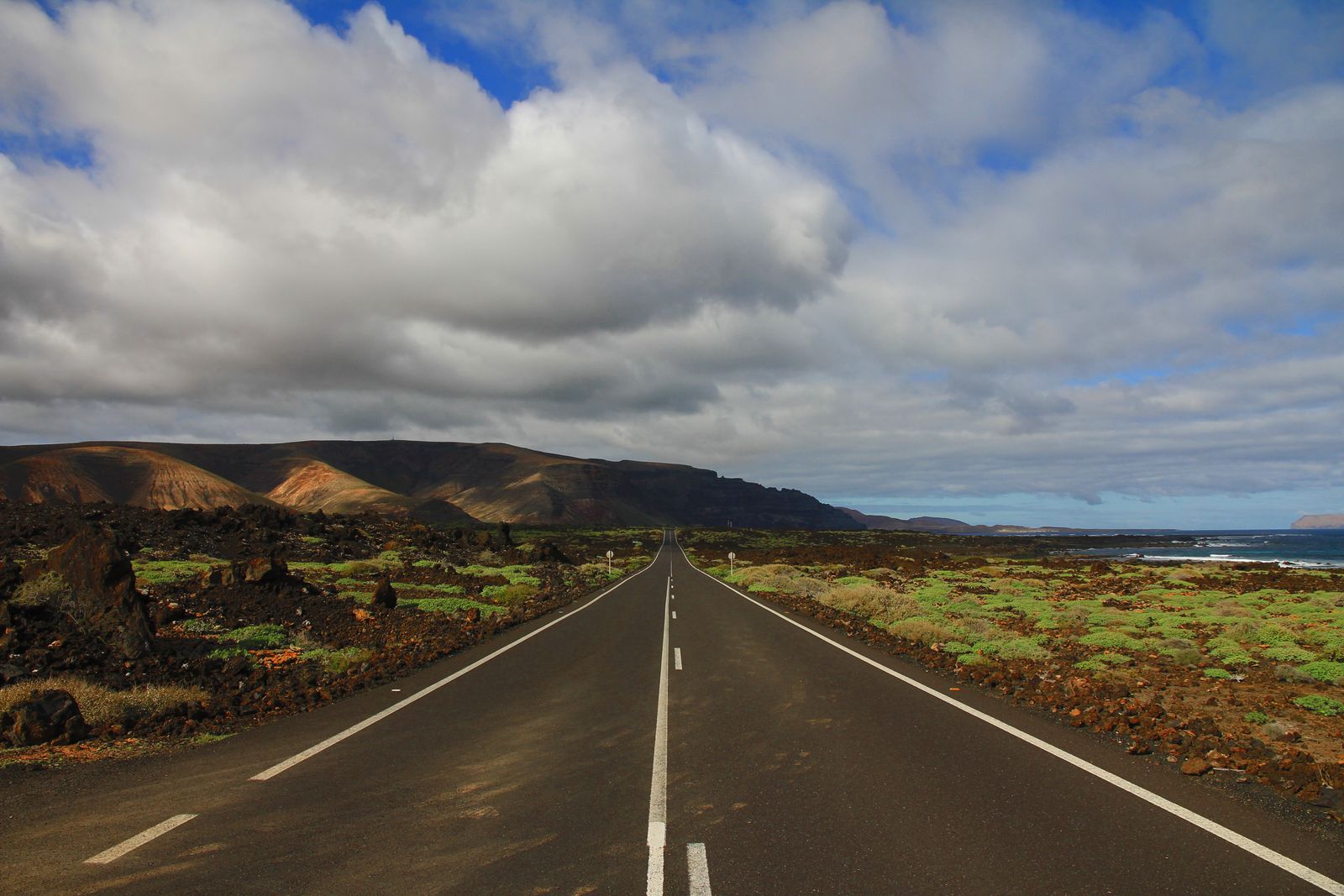 Open road running through a volcanic landscape, photo by Francesco Ungaro on Pexels