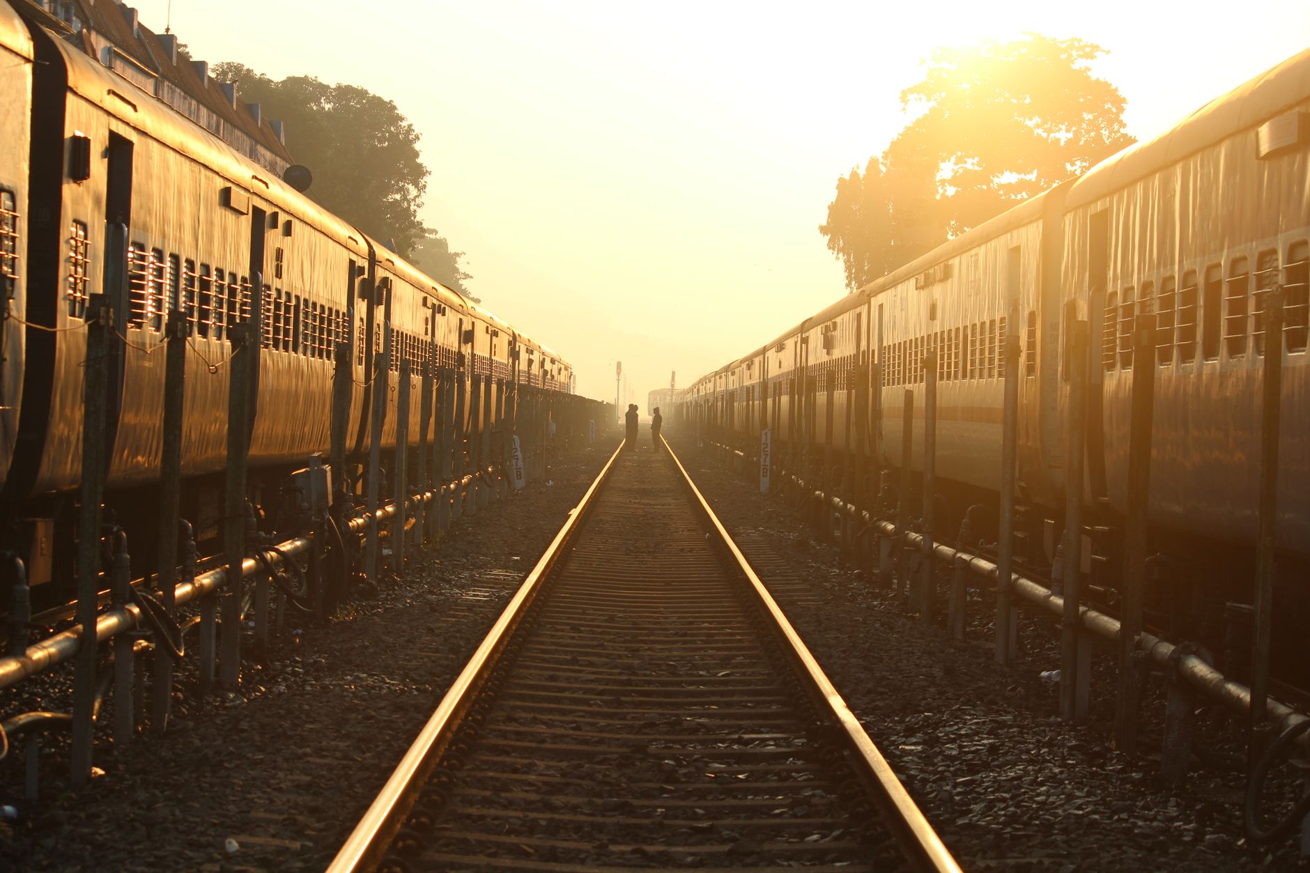 A captivating view of railway tracks at sunset, highlighting the beauty and symmetry of the scene.