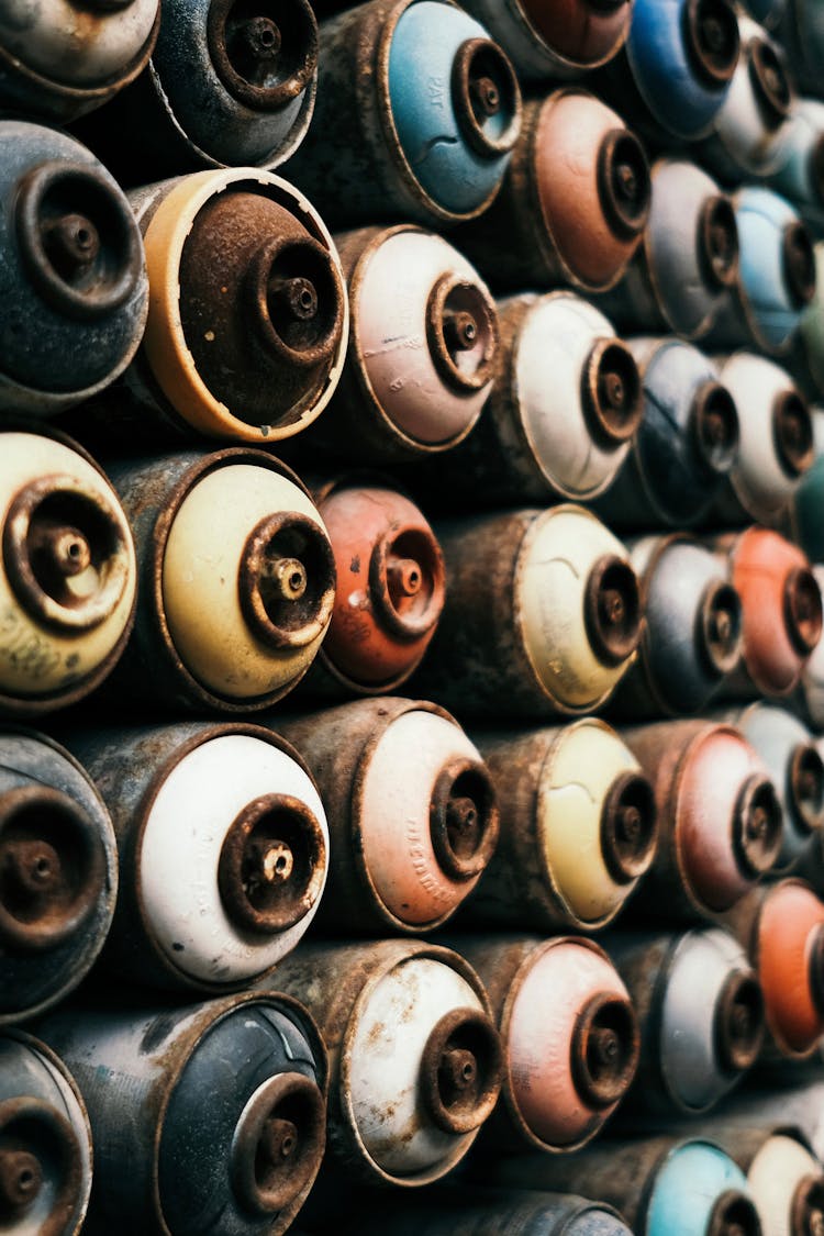 Stack Of Rusty Old Metal Spray Cans