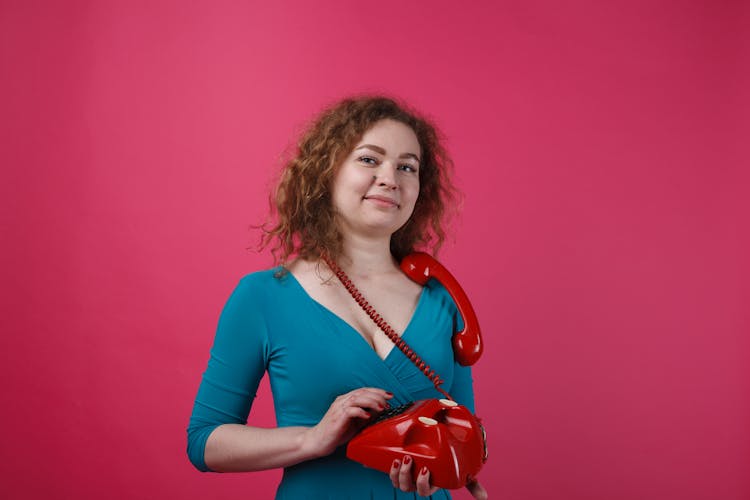 A Woman Holding A Telephone