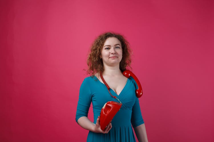 A Woman Holding A Telephone