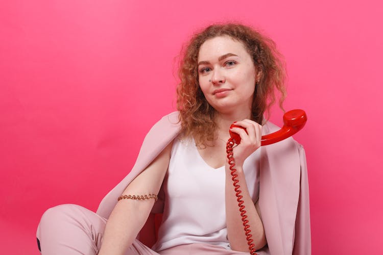 A Woman Holding A Telephone