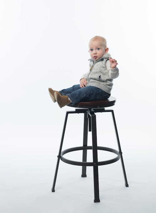 Free Child on Steel Framed Stool Stock Photo