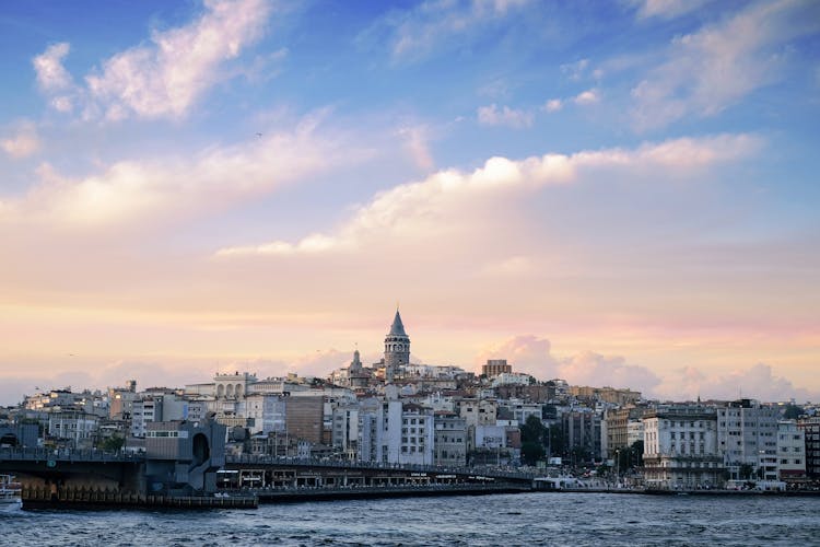 Cityscape With A Tower On A Hill And Bridge On River