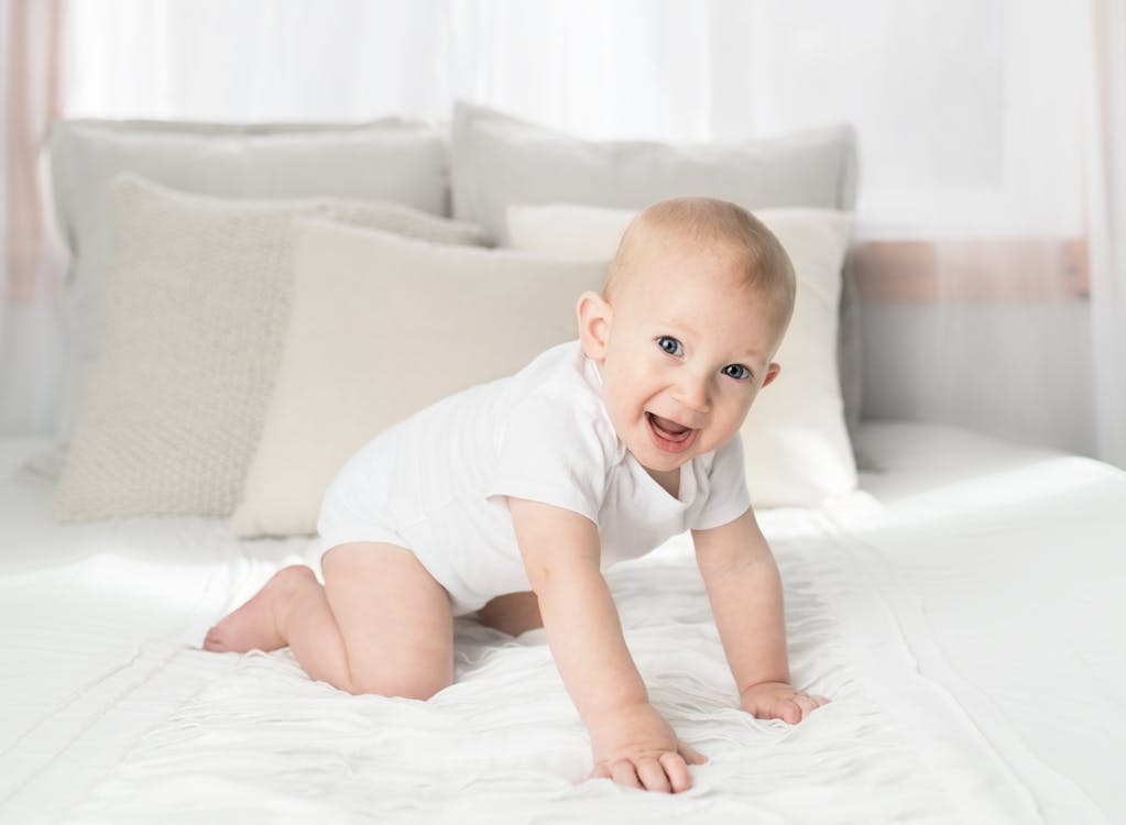 Free Baby On Bed Stock Photo