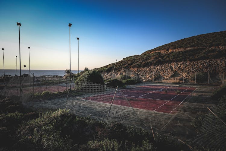 Sports Field Between Hill And Sea