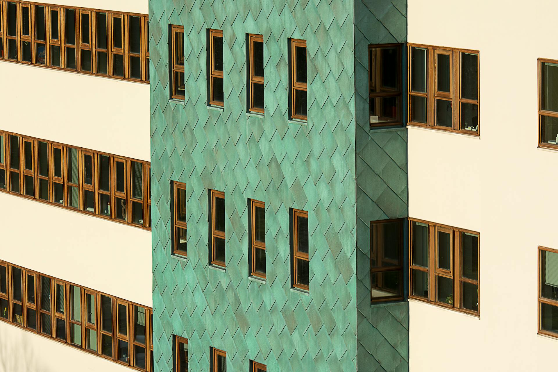 White and Green Concrete Building with Brown Wooden Framed Window