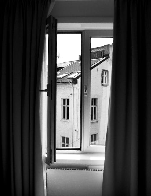 Grayscale Photography of Window Curtain and Window
