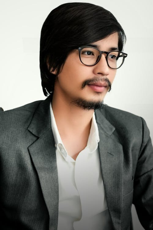 Man in Black Suit Jacket Wearing Black Framed Eyeglasses