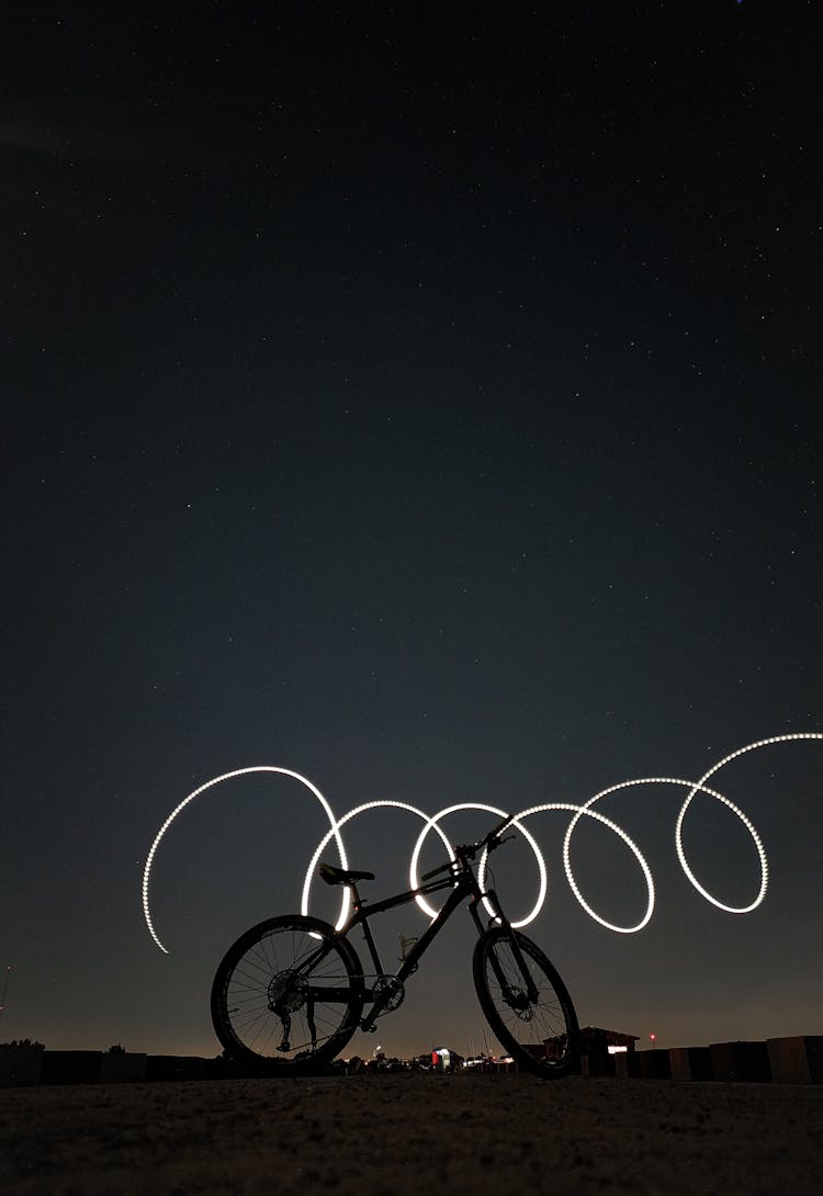 Low Angle Shot Of A Bike On A Camp And Spiral Light