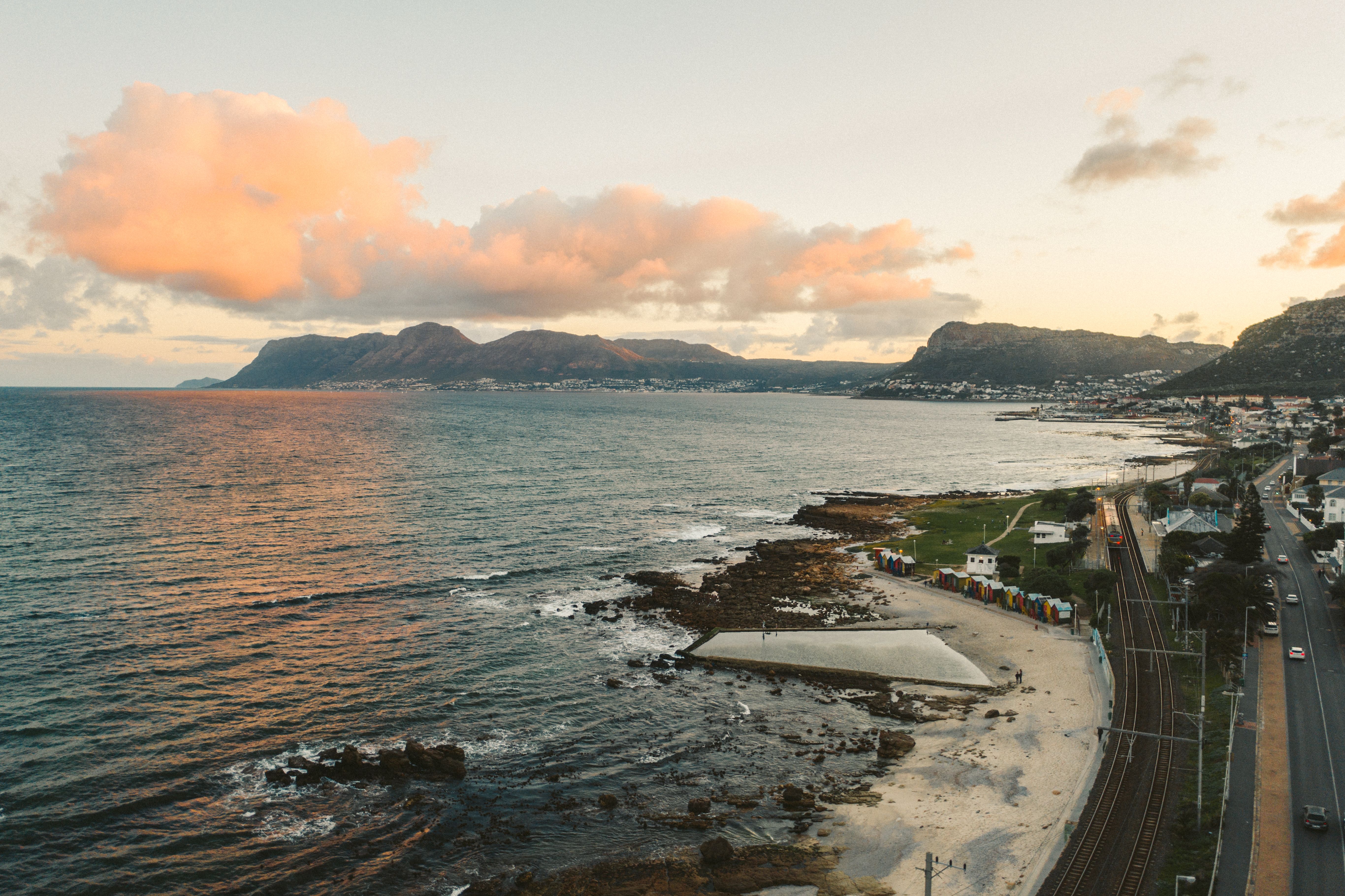 Unbeatable Cape Town City Center Tour with Champagne Review Review 2026 - A stunning aerial view of a coastal city with mountains at sunset.