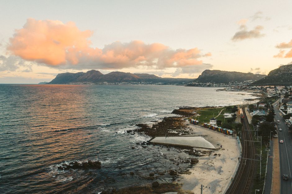 Unbeatable Cape Town City Center Tour with Champagne Review Review 2026 - A stunning aerial view of a coastal city with mountains at sunset.