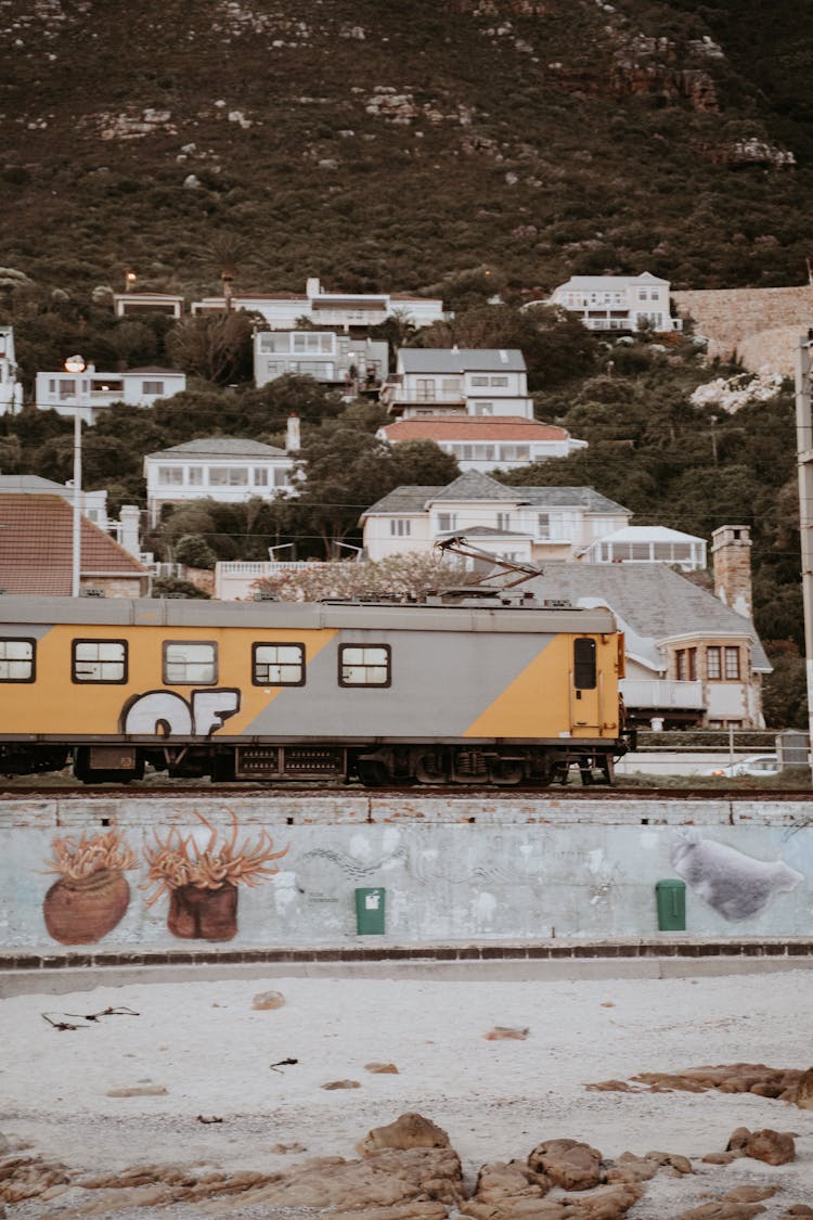 Yellow And Gray Train On Rail Tracks