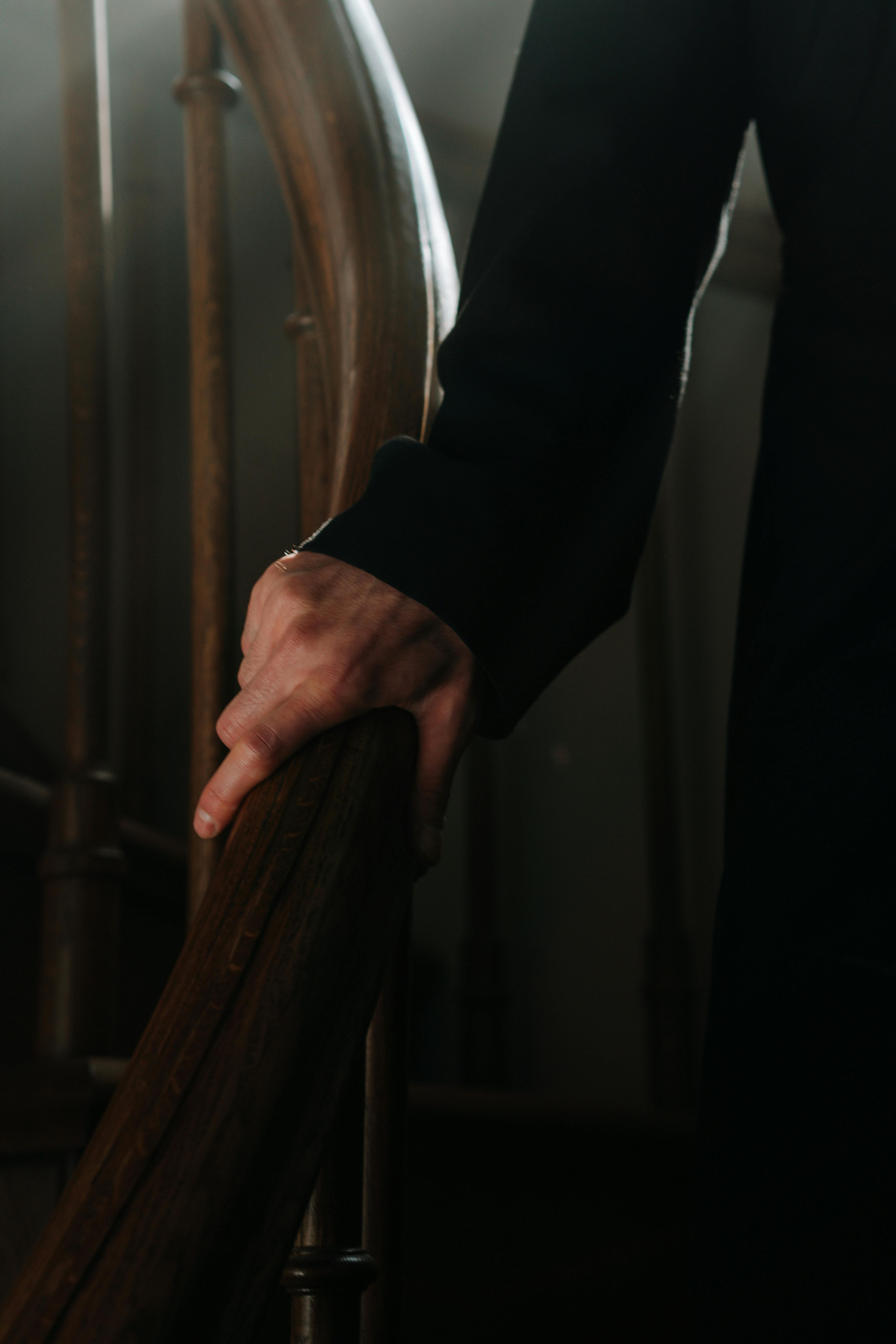 Older adult holding a handrail